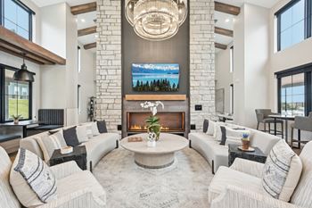 A modern living room with a fireplace and a large tv above it.